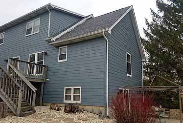 Big gray house with siding installed by siding contractor