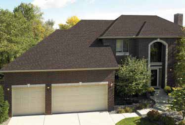 Big house with brick walls and garages with roof installed by roofing and siding contractors